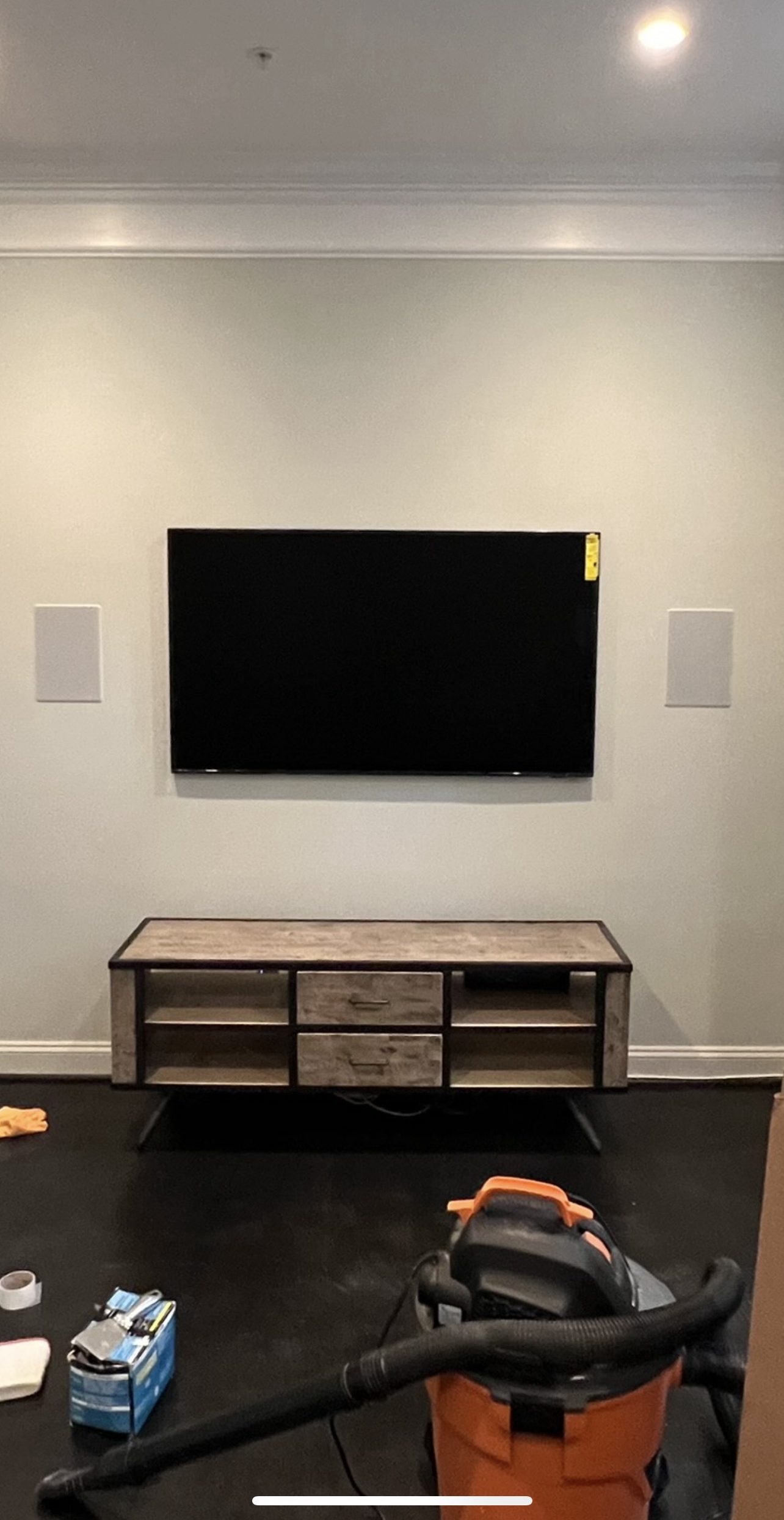 In-wall LCR pair flanking a mounted TV