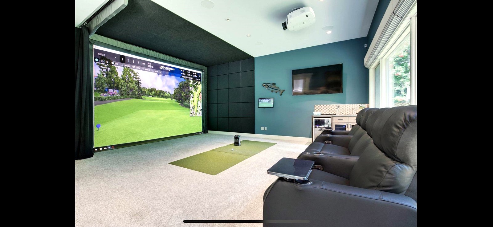 Teal golf simulator with theater seating