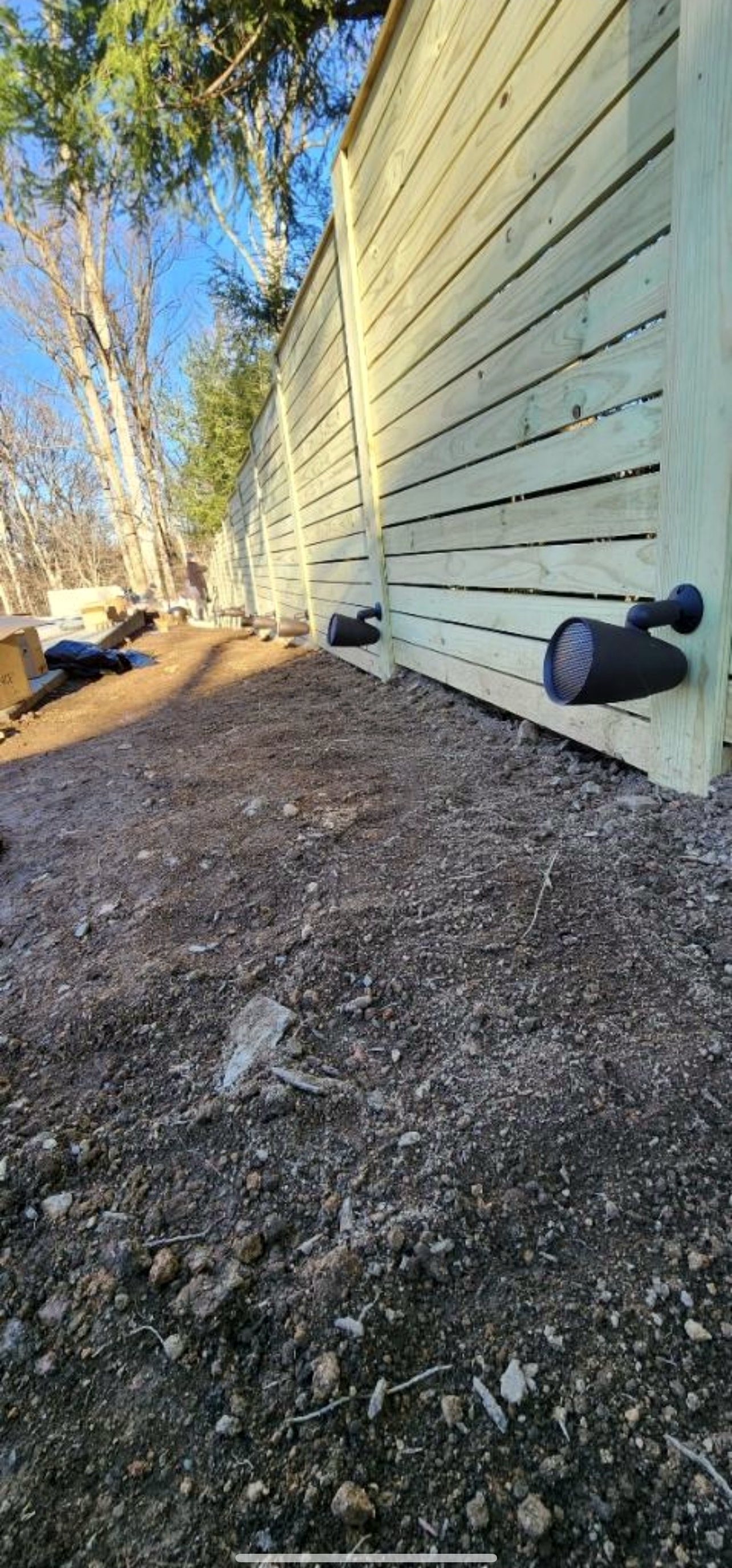 Outdoor speakers on cedar fence