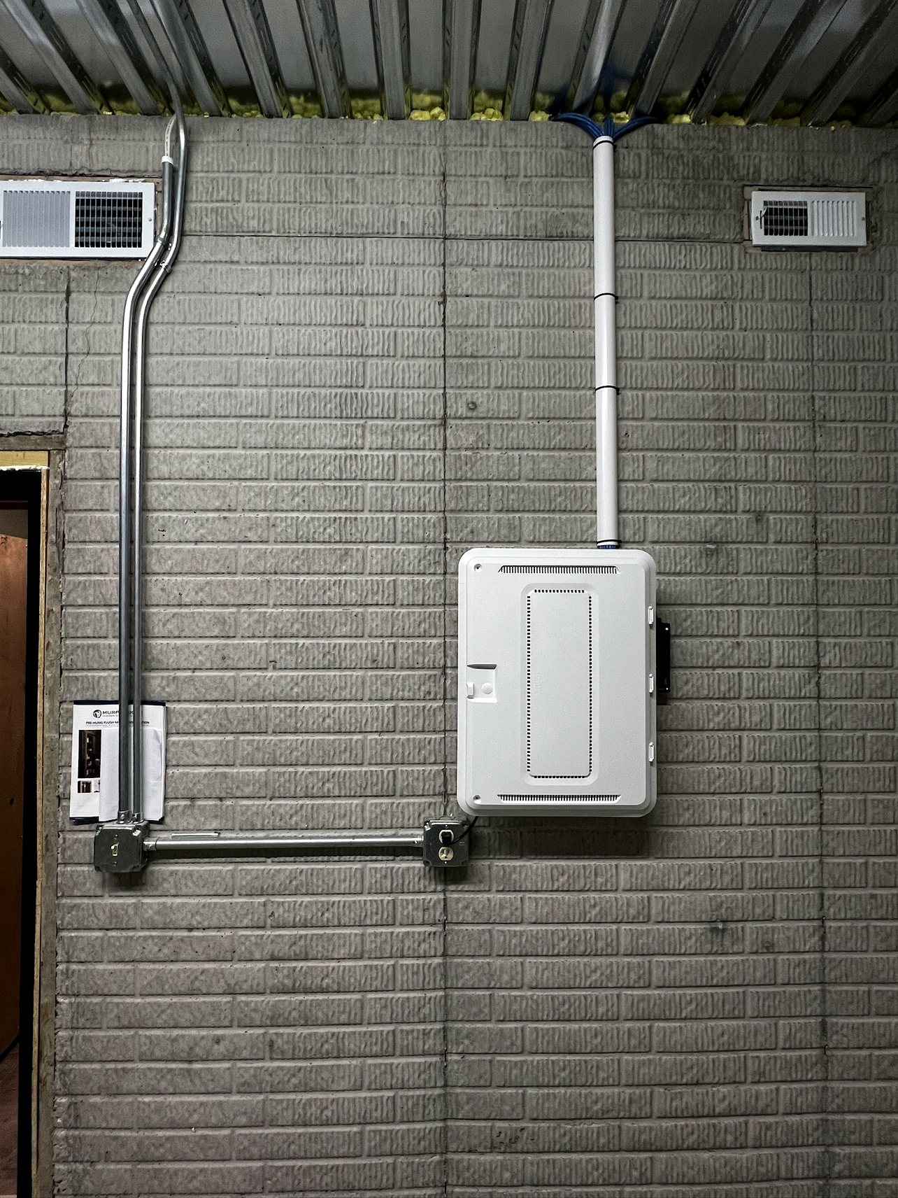 Structured wiring panel mounted to a cinderblock wall