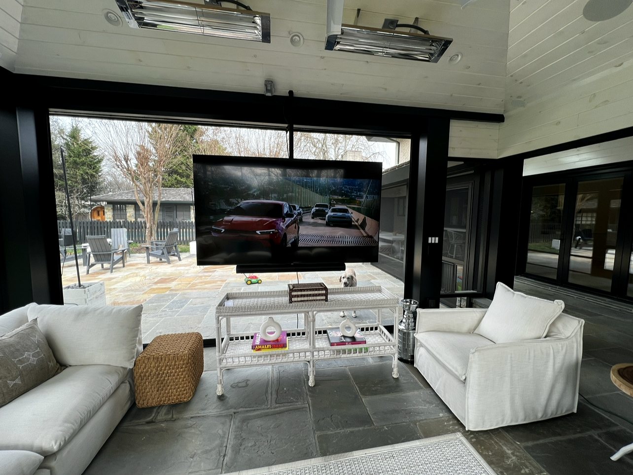 Patio sunroom with mounted TV and heaters