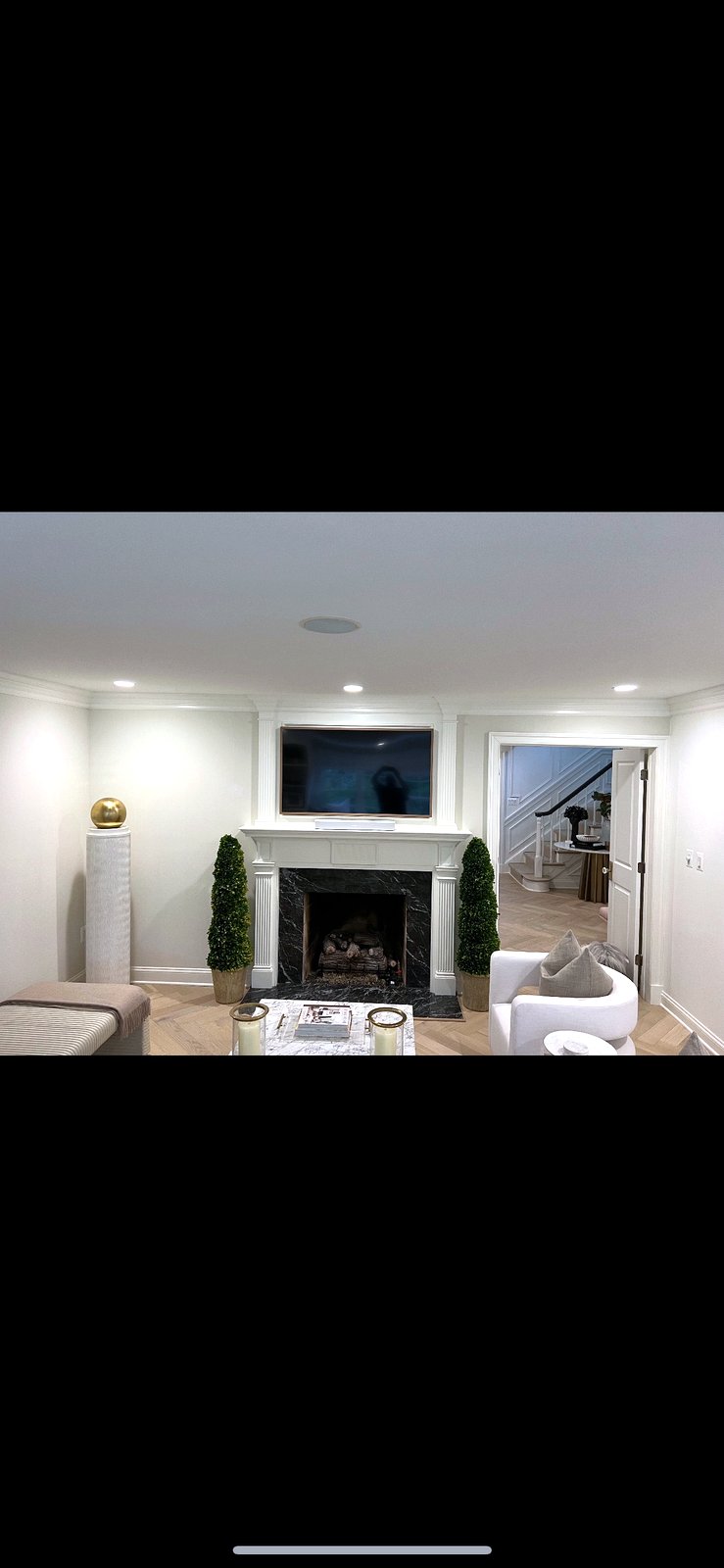 TV on soapstone mantel with in-ceiling speaker